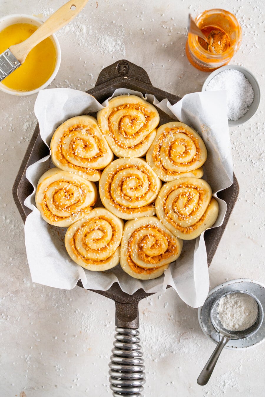 Tomato and Ricotta Pesto pull-apart buns. This easy bread dough has no eggs and no butter, making it the perfect easy dough. It is rolled out and filled with a tomato and ricotta pesto mixture and parmesan cheese, then rolled up and cut into buns and baked into perfect pull apart buns. These buns are great alongside a soup or as a delicious easy snack.