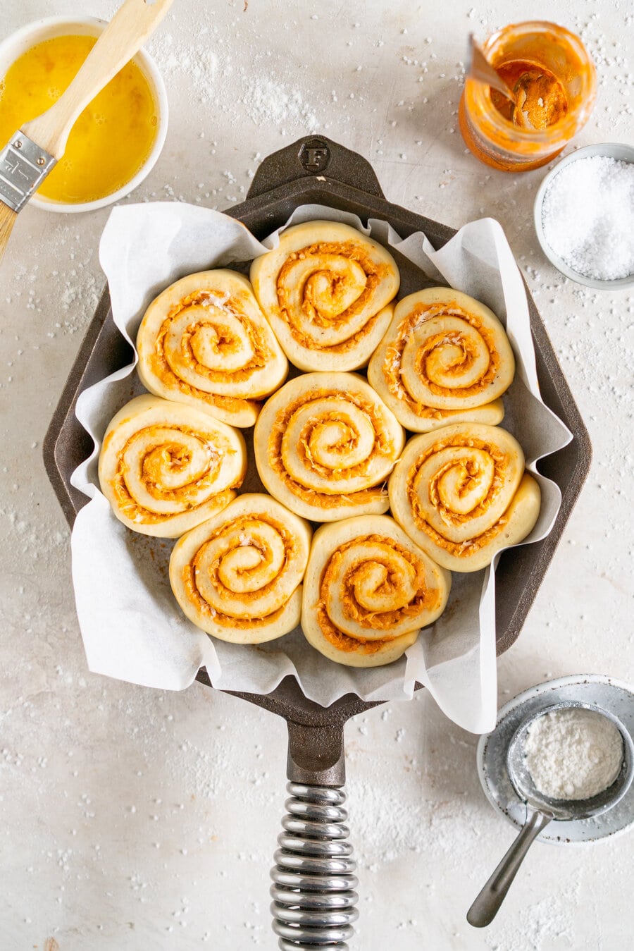 Tomato and Ricotta Pesto pull-apart buns. This easy bread dough has no eggs and no butter, making it the perfect easy dough. It is rolled out and filled with a tomato and ricotta pesto mixture and parmesan cheese, then rolled up and cut into buns and baked into perfect pull apart buns. These buns are great alongside a soup or as a delicious easy snack.