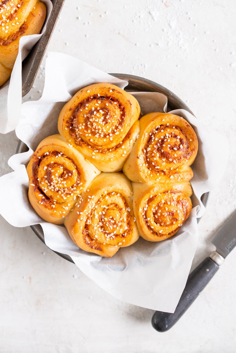 Tomato and Ricotta Pesto pull-apart buns. This easy bread dough has no eggs and no butter, making it the perfect easy dough. It is rolled out and filled with a tomato and ricotta pesto mixture and parmesan cheese, then rolled up and cut into buns and baked into perfect pull apart buns. These buns are great alongside a soup or as a delicious easy snack.