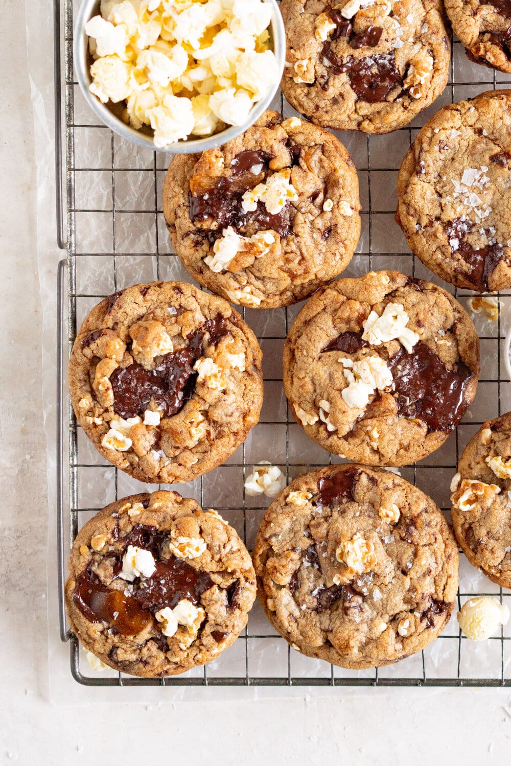 corner shot of popcorn with cookies on a rack over wax paper