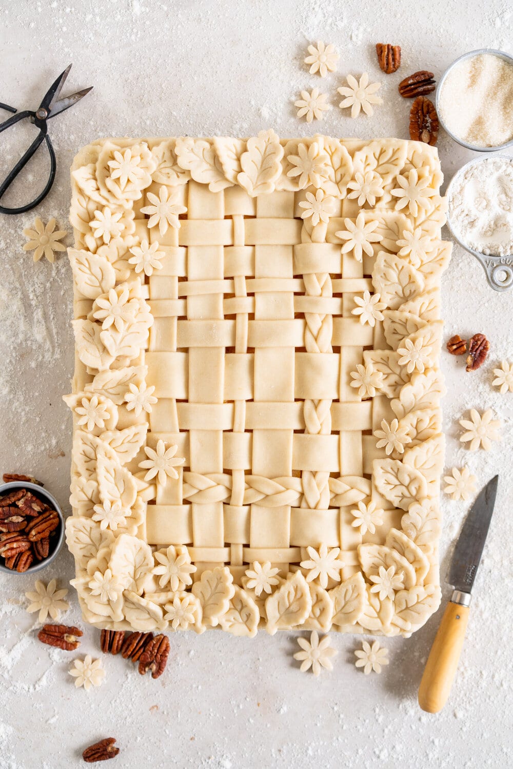 Peach Slab Pie with Candied Pecan no-churn Ice Cream. Flaky pastry surrounds a flavourful fresh peach filling. This slab pie is easy to make and is great for making ahead or serving a crowd. It is served with a candied pecan no-churn ice cream, which is filled with buttery pecan pieces in a creamy no-churn base. This is the perfect summer combination!