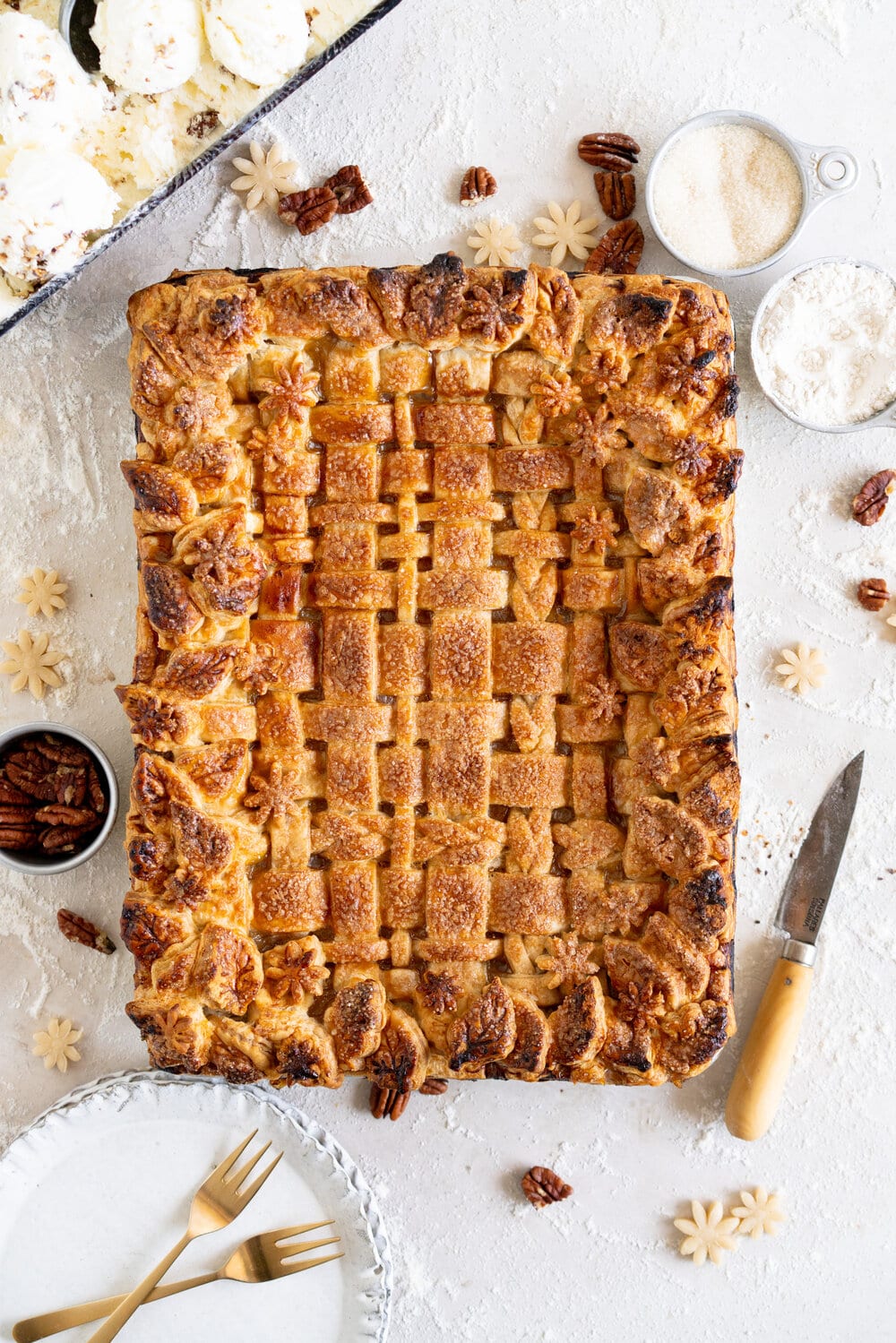 Peach Slab Pie with Candied Pecan no-churn Ice Cream. Flaky pastry surrounds a flavourful fresh peach filling. This slab pie is easy to make and is great for making ahead or serving a crowd. It is served with a candied pecan no-churn ice cream, which is filled with buttery pecan pieces in a creamy no-churn base. This is the perfect summer combination!