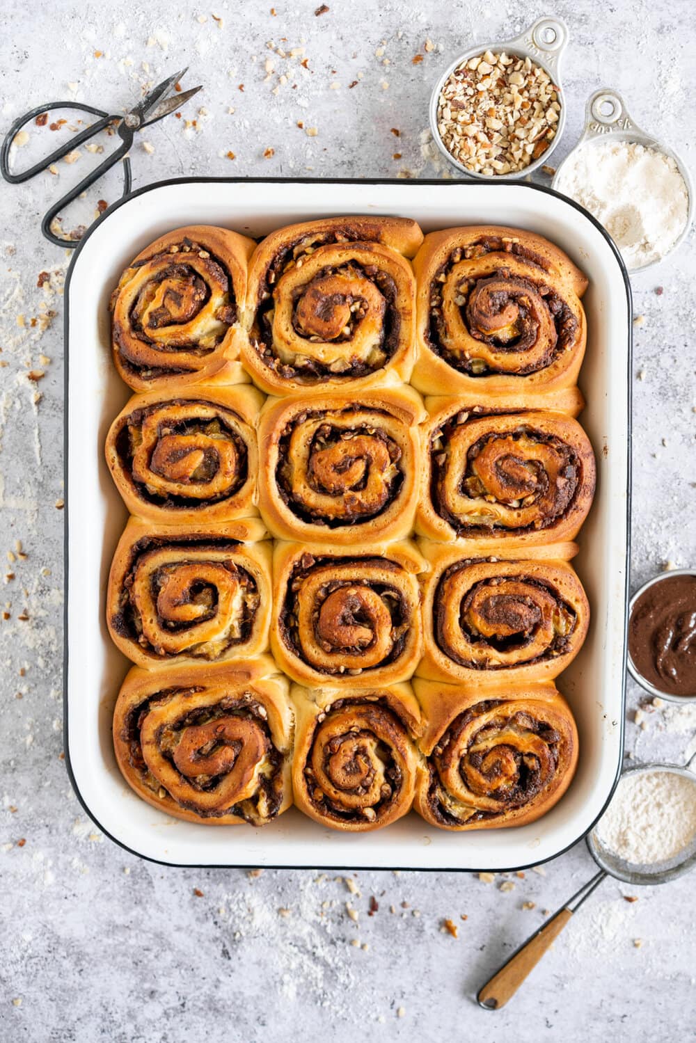 Nutella Banana and Hazelnut Sweet Rolls with Chocolate Cream Cheese Frosting. Soft, fluffy brioche is covered in nutella and bananas and sprinkled with hazelnuts, then rolled up into perfect sweet rolls and finished with a creamy and smooth chocolate cream cheese frosting. These are a great way to use up any extra bananas that you have around!