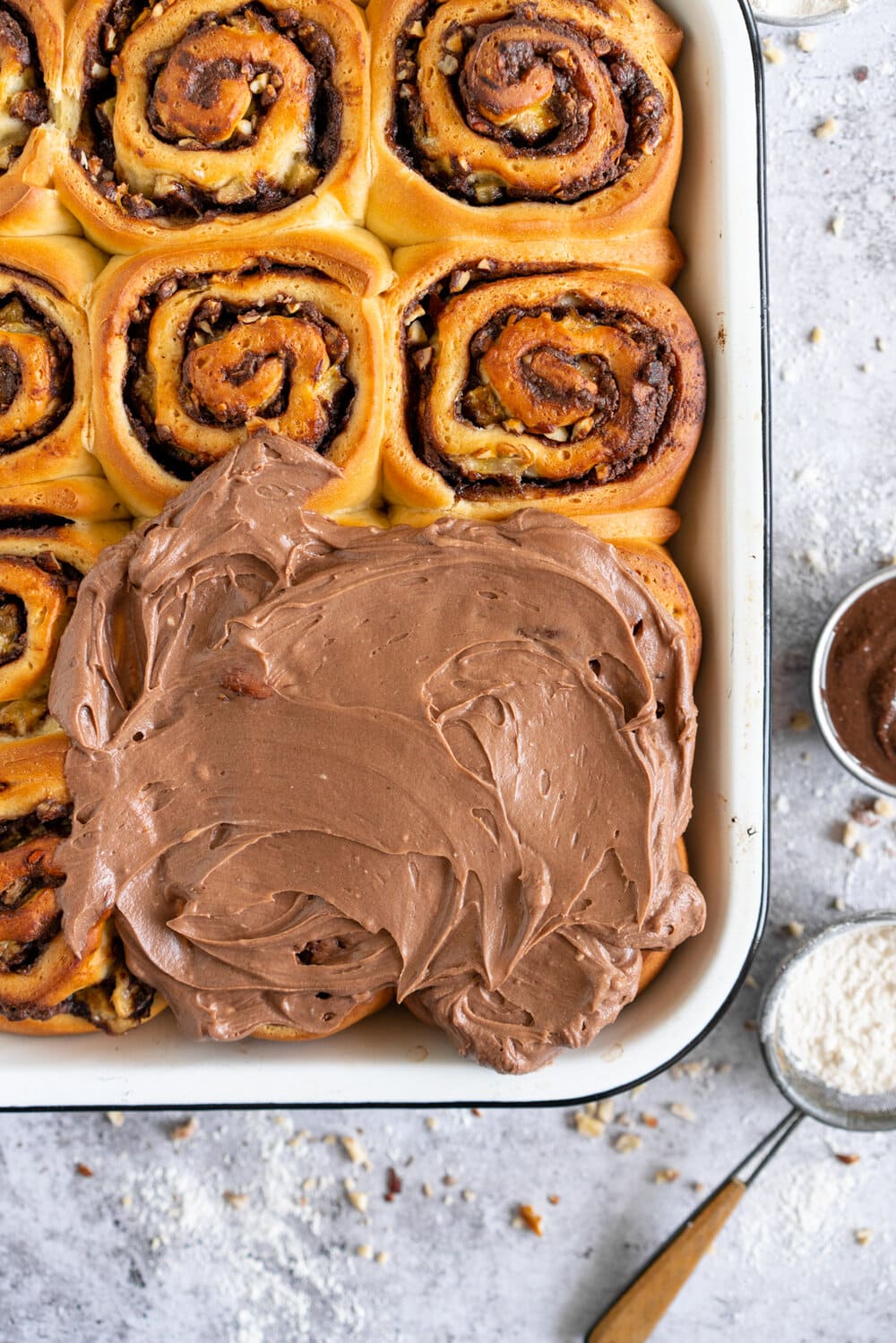 Nutella Banana and Hazelnut Sweet Rolls with Chocolate Cream Cheese Frosting. Soft, fluffy brioche is covered in nutella and bananas and sprinkled with hazelnuts, then rolled up into perfect sweet rolls and finished with a creamy and smooth chocolate cream cheese frosting. These are a great way to use up any extra bananas that you have around!