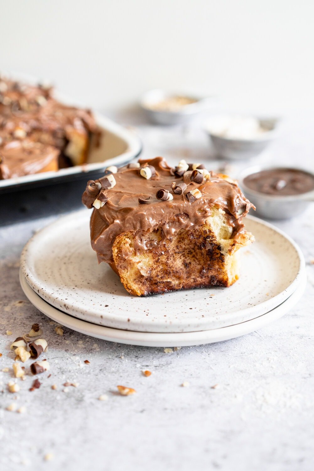 Nutella Banana and Hazelnut Sweet Rolls with Chocolate Cream Cheese Frosting. Soft, fluffy brioche is covered in nutella and bananas and sprinkled with hazelnuts, then rolled up into perfect sweet rolls and finished with a creamy and smooth chocolate cream cheese frosting. These are a great way to use up any extra bananas that you have around!