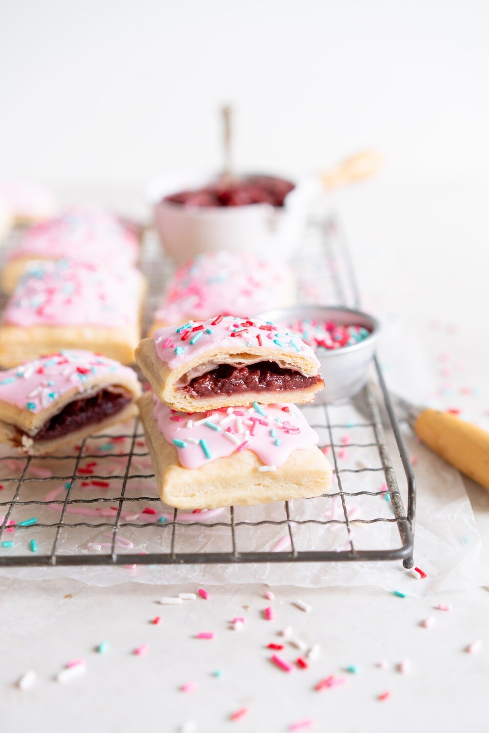 Roasted Strawberry and Balsamic Pop tarts. A slow roasted strawberry balsamic jam is used to fill a tender buttery pie dough to make perfect pop tarts, which are finished with a pink royal icing and sprinkles.