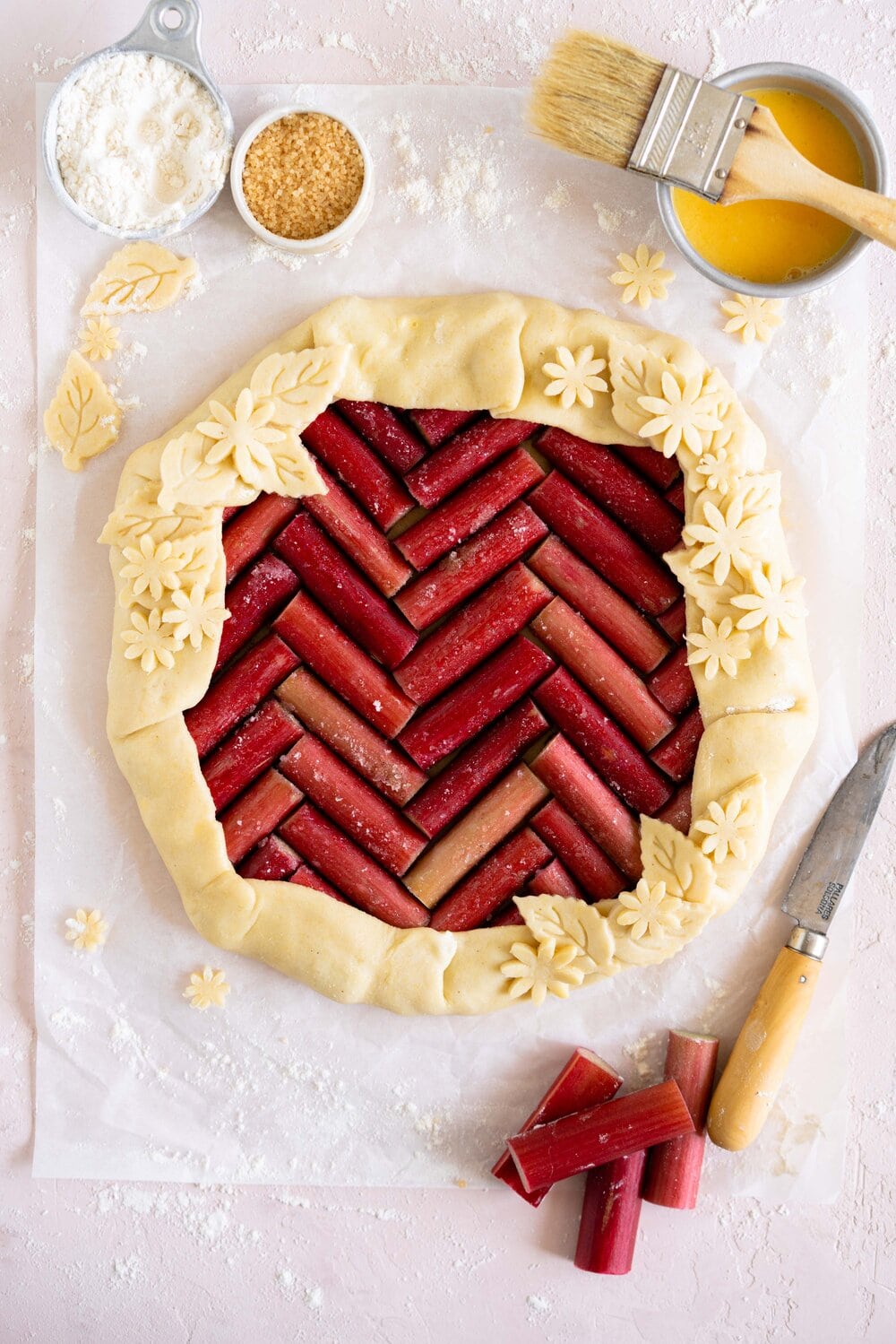 Rhubarb galette with a cornmeal crust. This easy rhubarb galette has a toasty cornmeal crust and a beautiful herringbone pattern. This galette is an easy spring dessert and is the perfect way to bake with rhubarb.