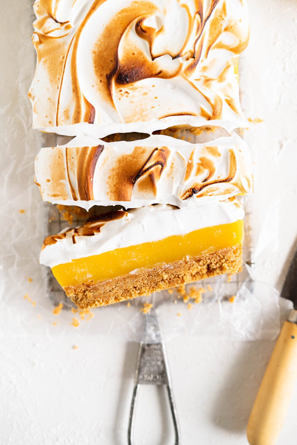 Small Batch No-Bake Passionfruit and Lemon Meringue Bars. A buttery graham crust is topped with a smooth lemon and passionfruit filling, and topped with a torched Swiss meringue. These lemon and passionfruit bars are easy to make and do not need an oven, making them the perfect summer dessert!