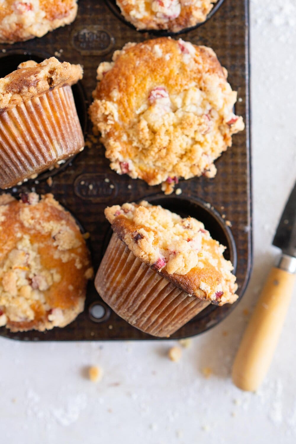 Rhubarb Streusel Muffins - a moist muffin base is studded with fresh rhubarb chunks and topped with a crunchy streusel crumble topping which is lightly flavoured with lemon zest and vanilla. This easy streusel muffin recipe can be made with any fruit but is perfect made with fresh rhubarb.