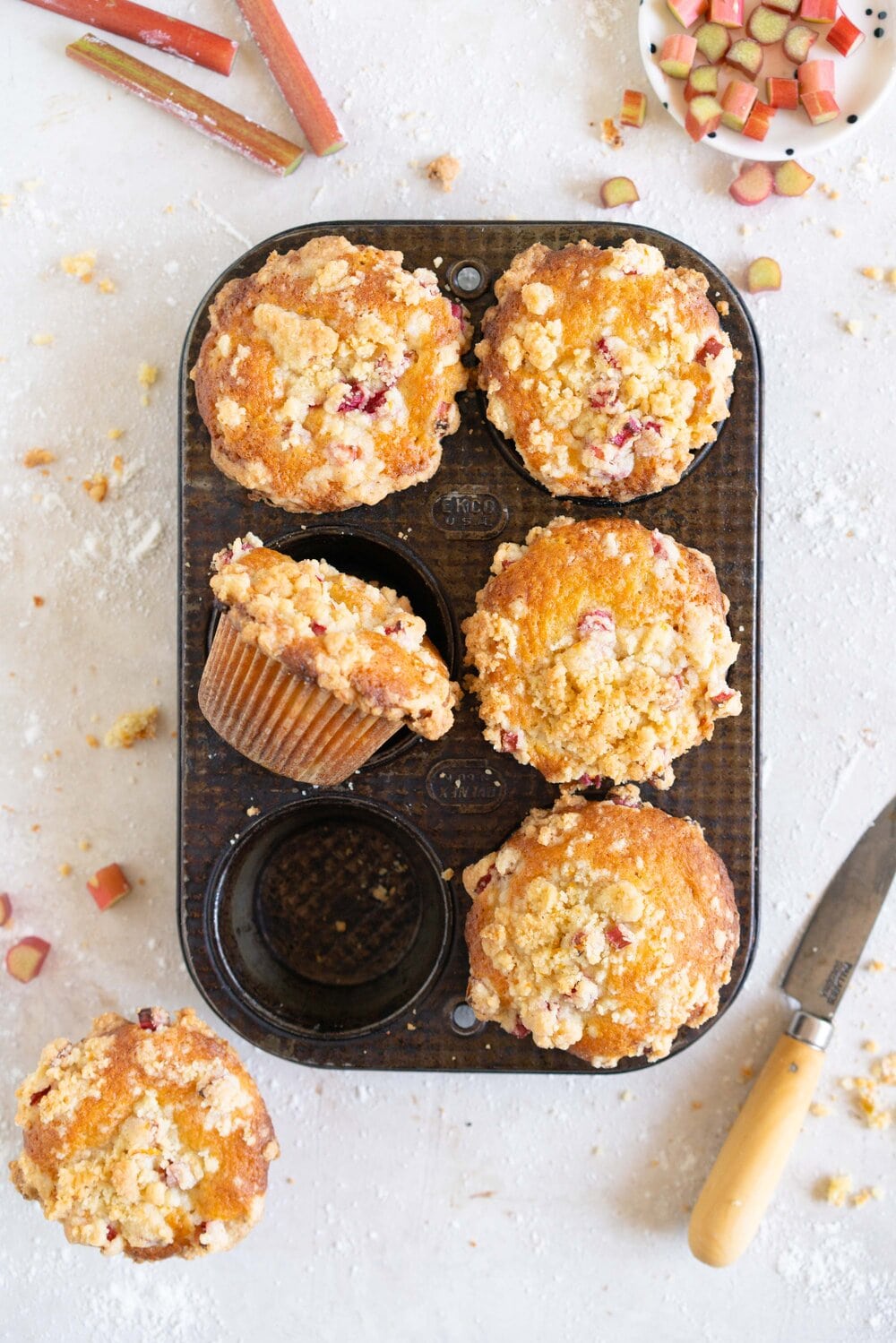 Rhubarb Streusel Muffins - a moist muffin base is studded with fresh rhubarb chunks and topped with a crunchy streusel crumble topping which is lightly flavoured with lemon zest and vanilla. This easy streusel muffin recipe can be made with any fruit but is perfect made with fresh rhubarb.