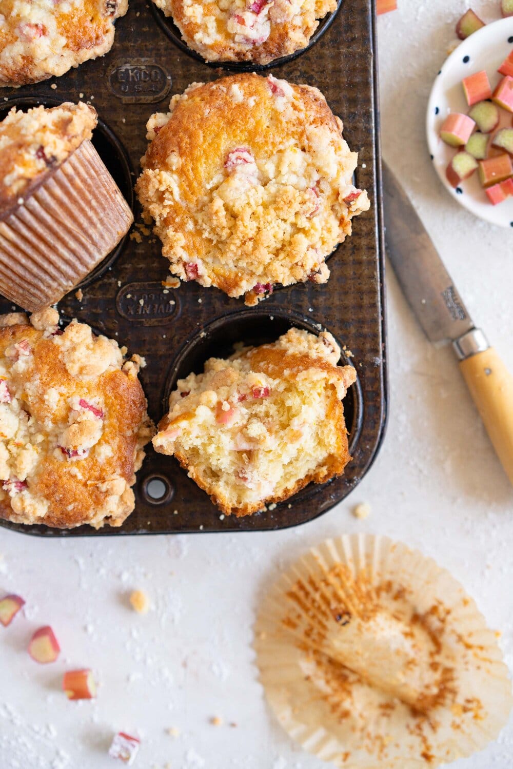 Rhubarb Streusel Muffins - a moist muffin base is studded with fresh rhubarb chunks and topped with a crunchy streusel crumble topping which is lightly flavoured with lemon zest and vanilla. This easy streusel muffin recipe can be made with any fruit but is perfect made with fresh rhubarb.