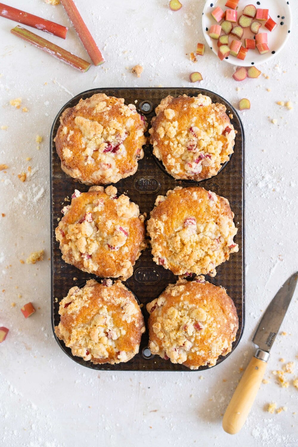 Rhubarb Streusel Muffins - a moist muffin base is studded with fresh rhubarb chunks and topped with a crunchy streusel crumble topping which is lightly flavoured with lemon zest and vanilla. This easy streusel muffin recipe can be made with any fruit but is perfect made with fresh rhubarb.