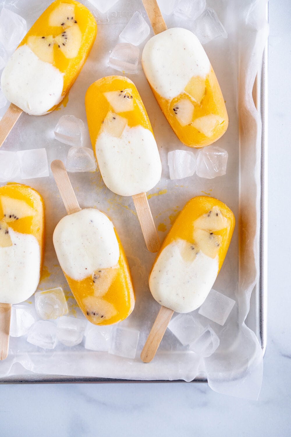 Kiwifruit and Mango Popsicles. Creamy Kiwifruit whipped cream and smooth mango puree are combined into this perfect popsicle. These pops are gluten free and super refreshing, and are great for using up summer fruit. There is no cooking required - simply blend up your fruit and you are ready to go!