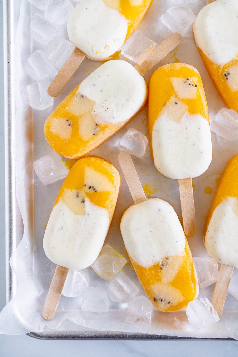 Kiwifruit and Mango Popsicles. Creamy Kiwifruit whipped cream and smooth mango puree are combined into this perfect popsicle. These pops are gluten free and super refreshing, and are great for using up summer fruit. There is no cooking required - simply blend up your fruit and you are ready to go!