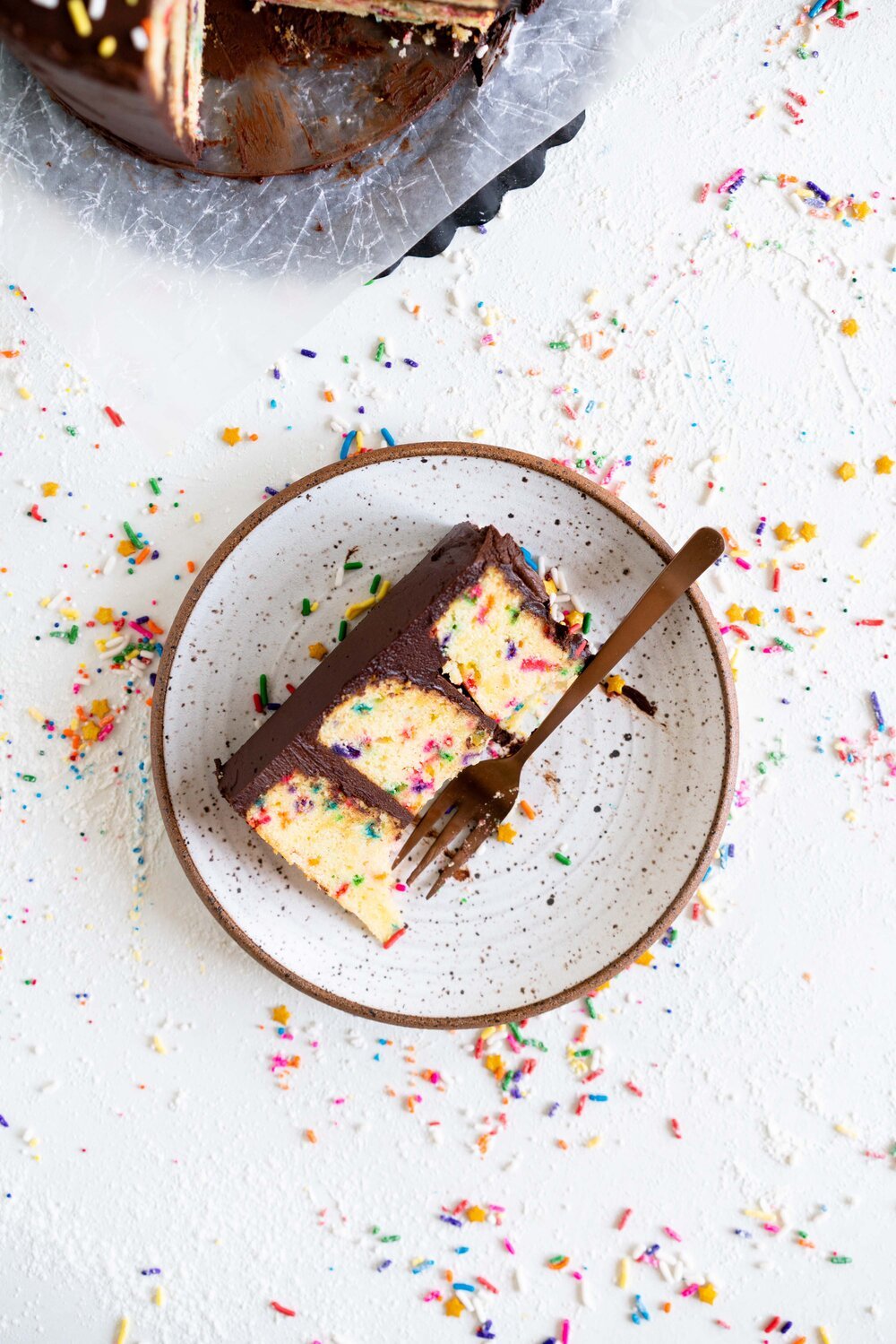 The most delicious, moist funfetti vanilla bean cake. This homemade funfetti cake has a yellow cake base and is made with buttermilk to keep it perfectly dense, and is packed full of Jimmy sprinkles. The confetti cake is layered with a rich chocolate American Buttercream frosting, and finished with more sprinkles. This is the perfect celebration cake, and at six inches it is great for a small group.