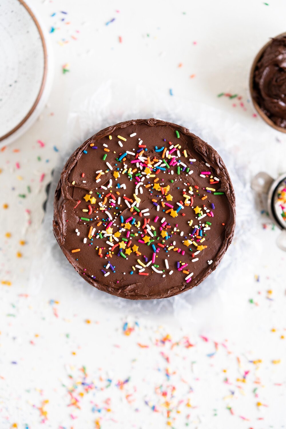 The most delicious, moist funfetti vanilla bean cake. This homemade funfetti cake has a yellow cake base and is made with buttermilk to keep it perfectly dense, and is packed full of Jimmy sprinkles. The confetti cake is layered with a rich chocolate American Buttercream frosting, and finished with more sprinkles. This is the perfect celebration cake, and at six inches it is great for a small group.