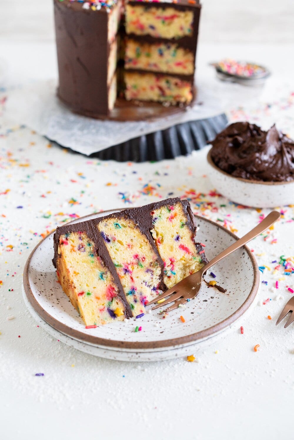 The most delicious, moist funfetti vanilla bean cake. This homemade funfetti cake has a yellow cake base and is made with buttermilk to keep it perfectly dense, and is packed full of Jimmy sprinkles. The confetti cake is layered with a rich chocolate American Buttercream frosting, and finished with more sprinkles. This is the perfect celebration cake, and at six inches it is great for a small group.
