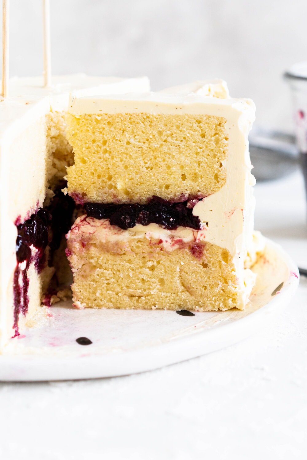 Two Layer Vanilla Bean Buttermilk Cake with Cherry Compote and Vanilla Bean Swiss Meringue Buttercream. This small two-layer cake is perfect for a celebration with a small group. The cake is tender from the reverse creaming method, and the Swiss meringue buttercream is smooth and silky. This is the perfect vanilla bean cake!