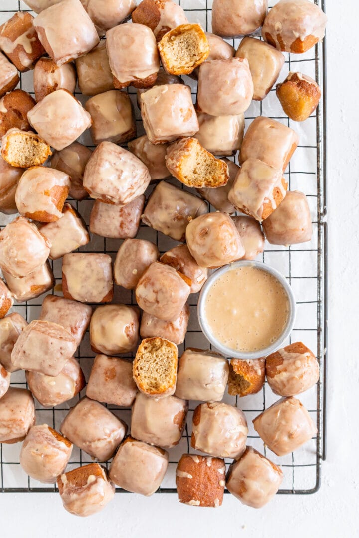 Earl Grey Doughnut Bites on a rack with some with bites taken out