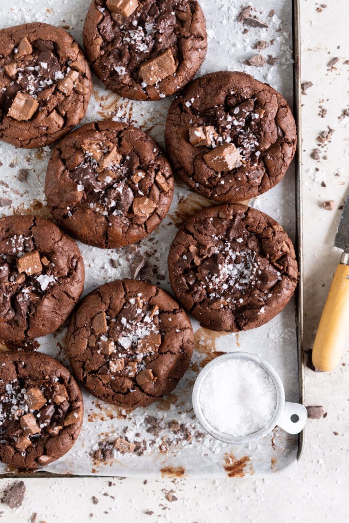 Corner of a pan covered in dark chocolate olive oil cookies