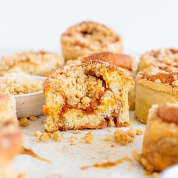 Cut shot of an apricot crumb bun showing the apricot filling and streusel topping