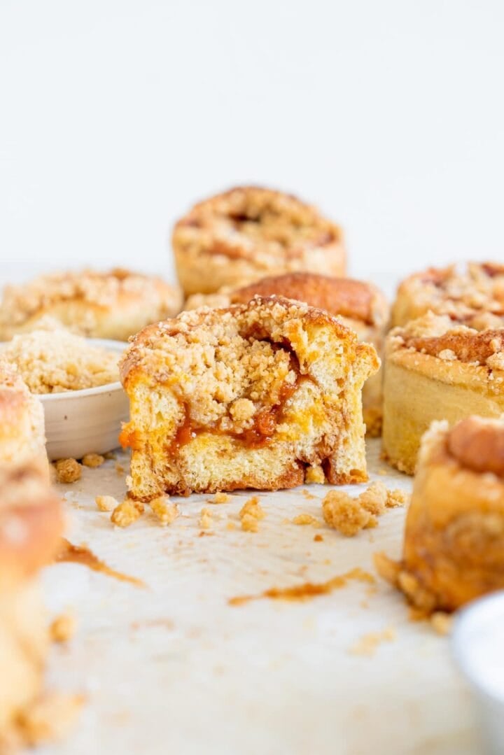 Cut shot of an apricot crumb bun showing the apricot filling and streusel topping