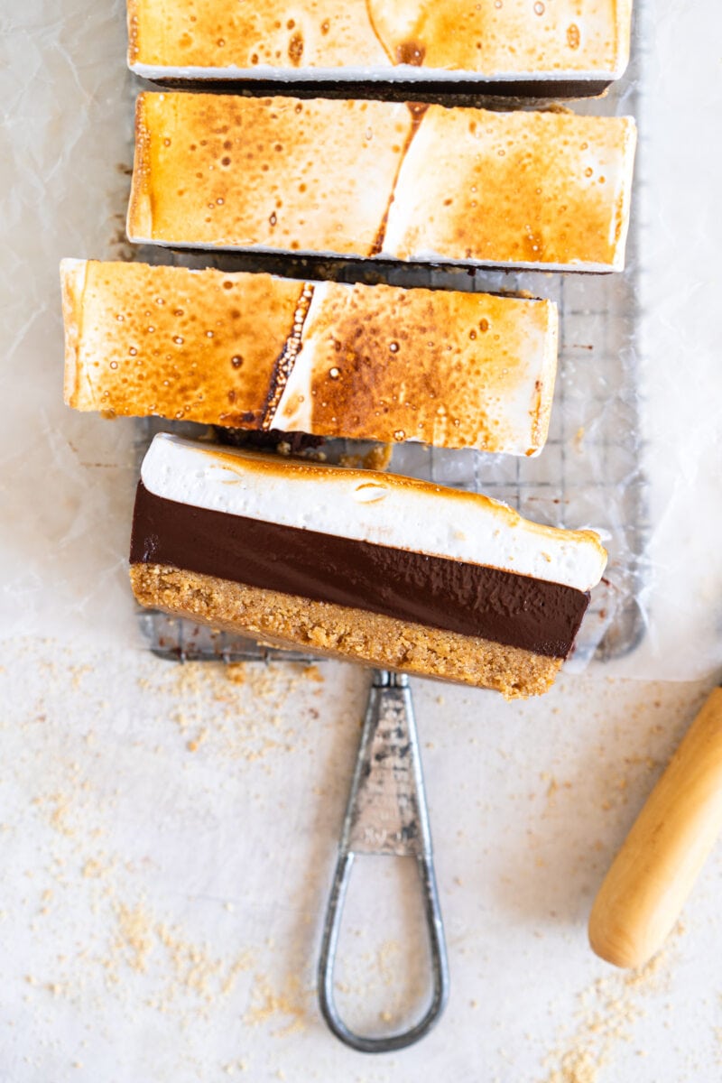 Cut shot of s'mores bars showing chocolate filling and marshmallow layer