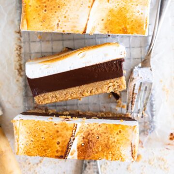 Close up shot showing interior of s'mores bar with a bite taken out with a fork.