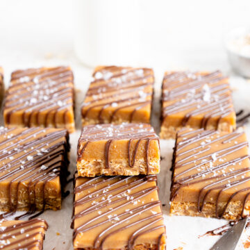 side on shot of ginger caramel slice showing the cut shot and drizzled chocolate