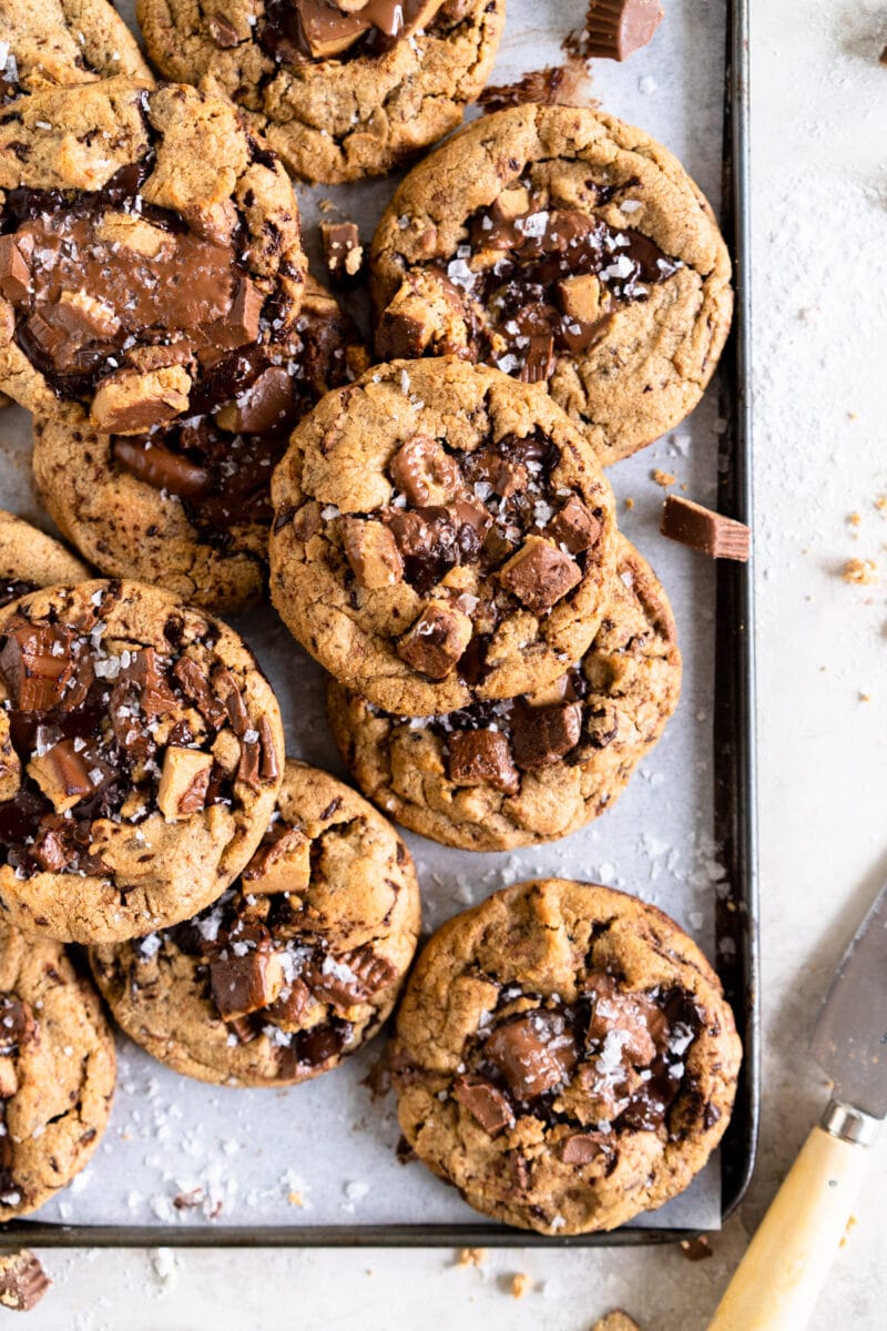 layered chocolate chip cookies on a baking sheet.