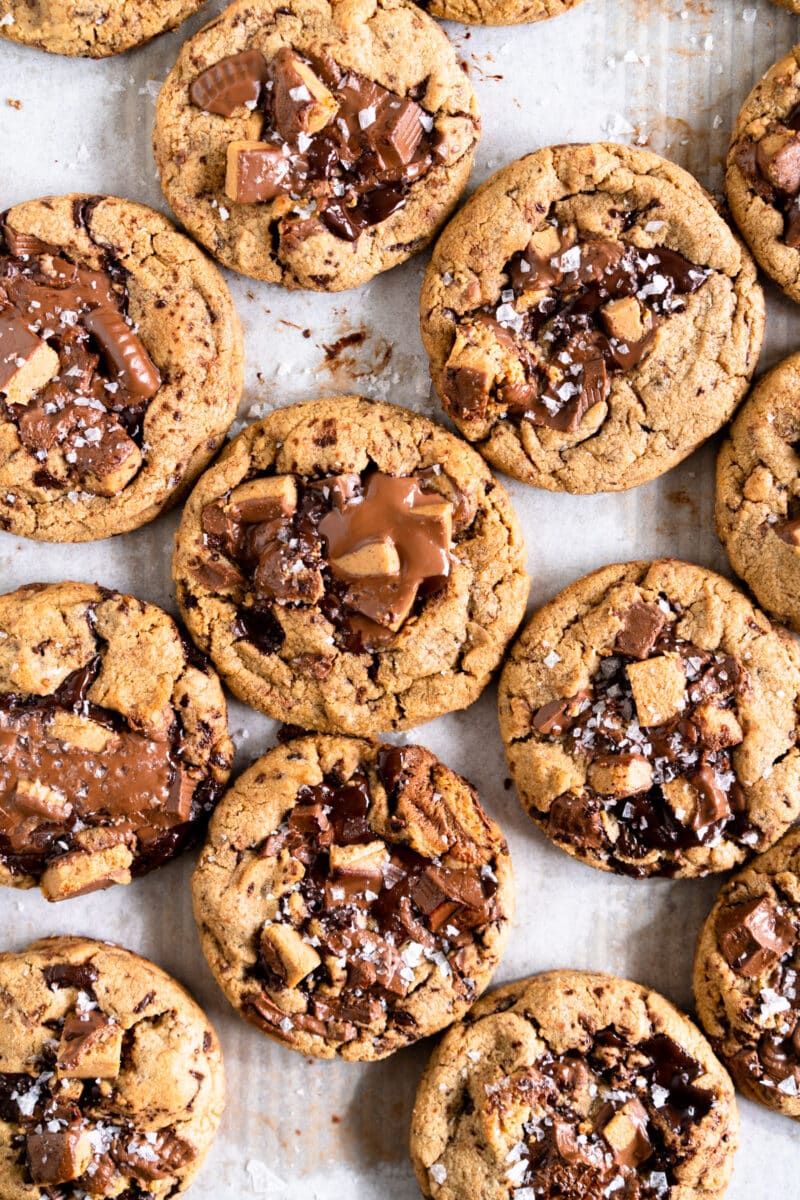 Peanut Butter Cup cookies on baking sheet with melted chocolate puddles on the top.