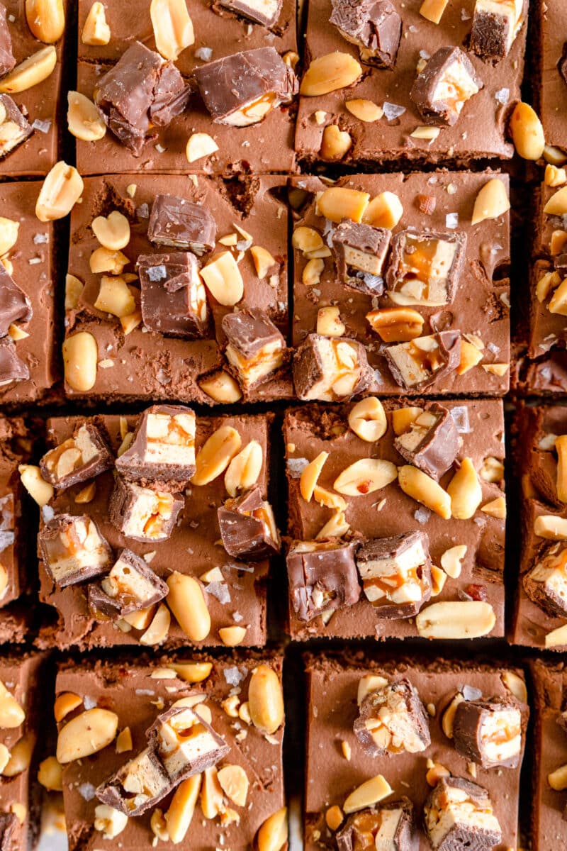 Top down shot of snickers cheesecake top with snickers and peanuts