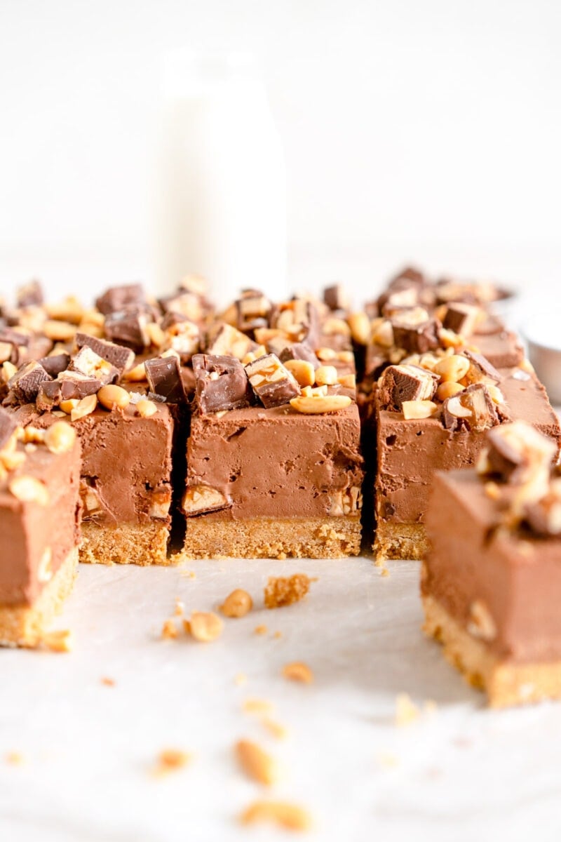 Chocolate Snickers Cheesecake topped with Snickers bar and Chopped Peanuts
