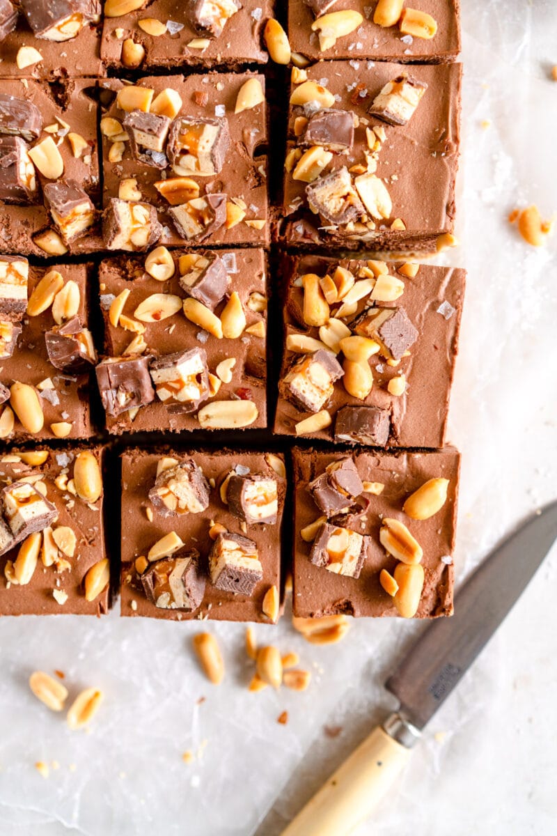 slices of chocolate cheesecake with snickers topping