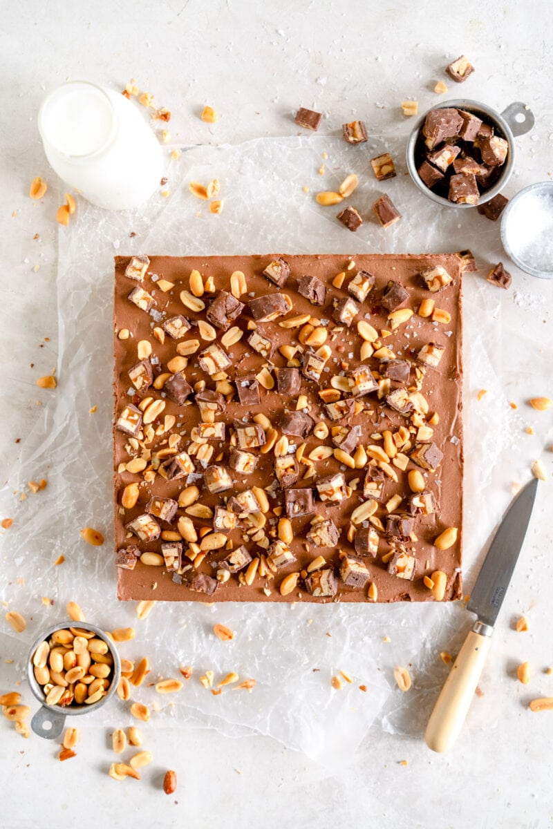 Top Down shot of chocolate cheesecake with peanuts and snickers