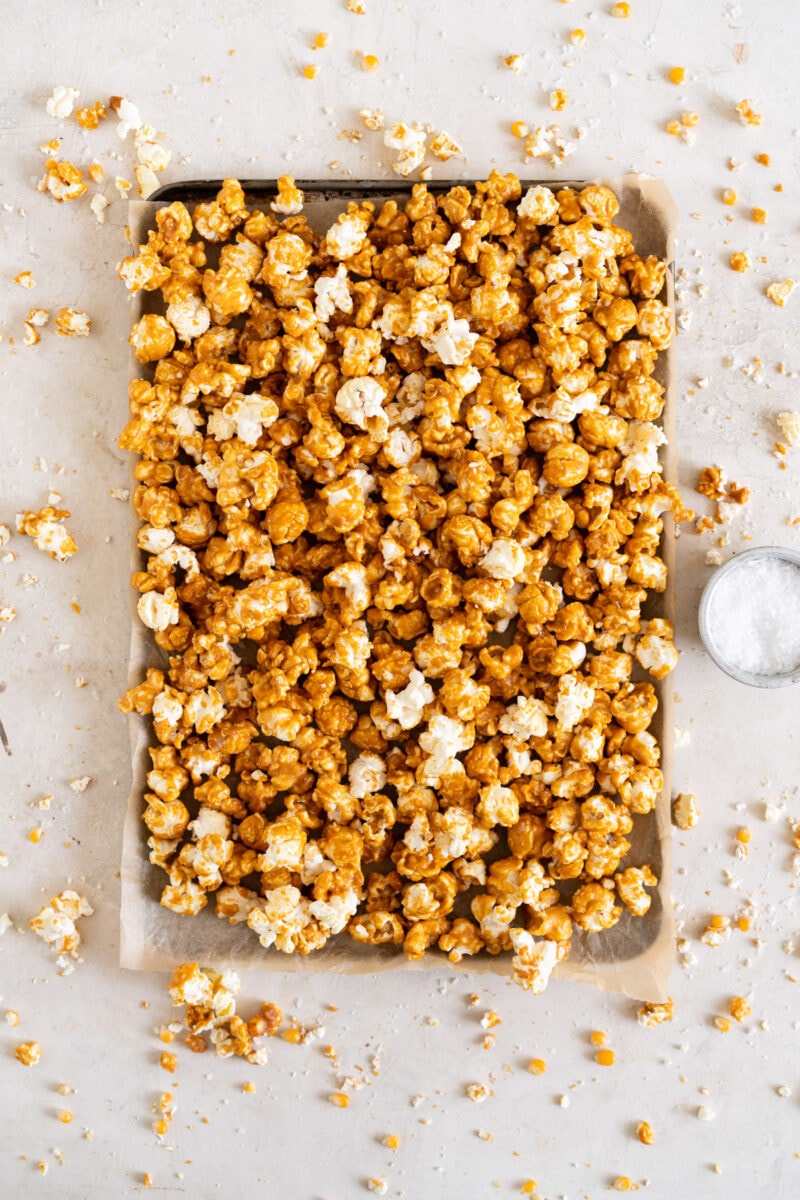 Pulled back shot of tahini caramel corn on sheet pan.