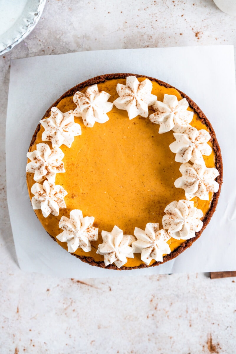top down shot of pumpkin cheesecake with whipped cream