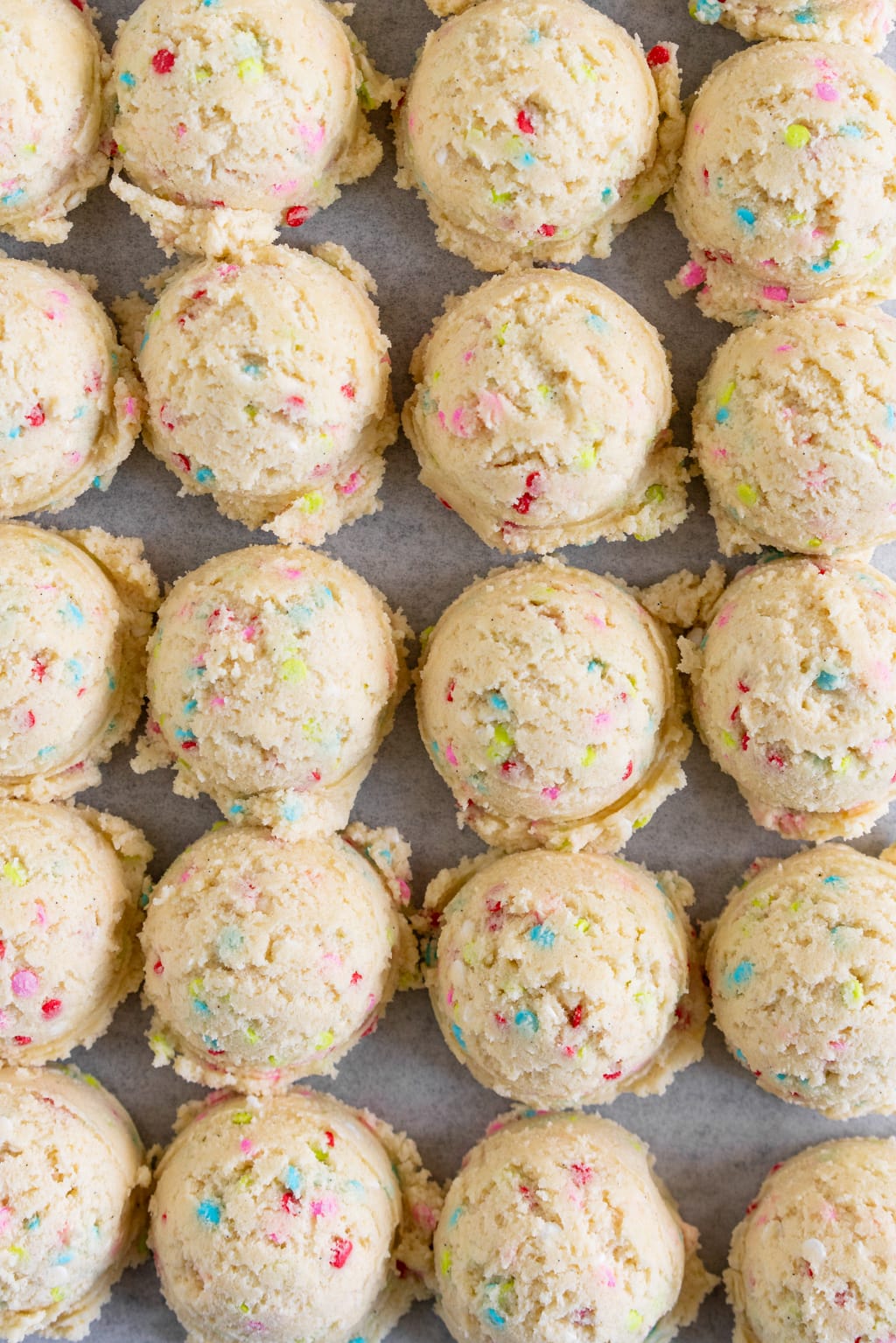 balls of funfetti sugar cookie dough ready to bake
