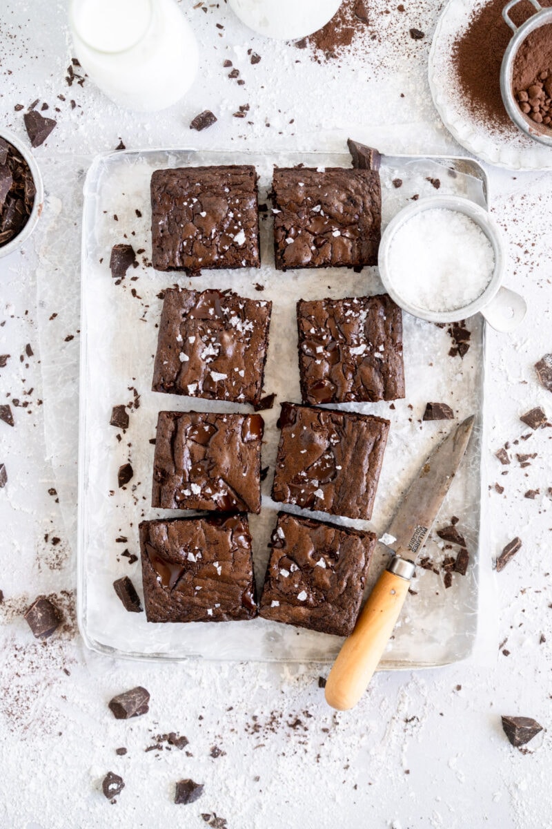 close up of sliced small batch dairy free brownies on tray with salt