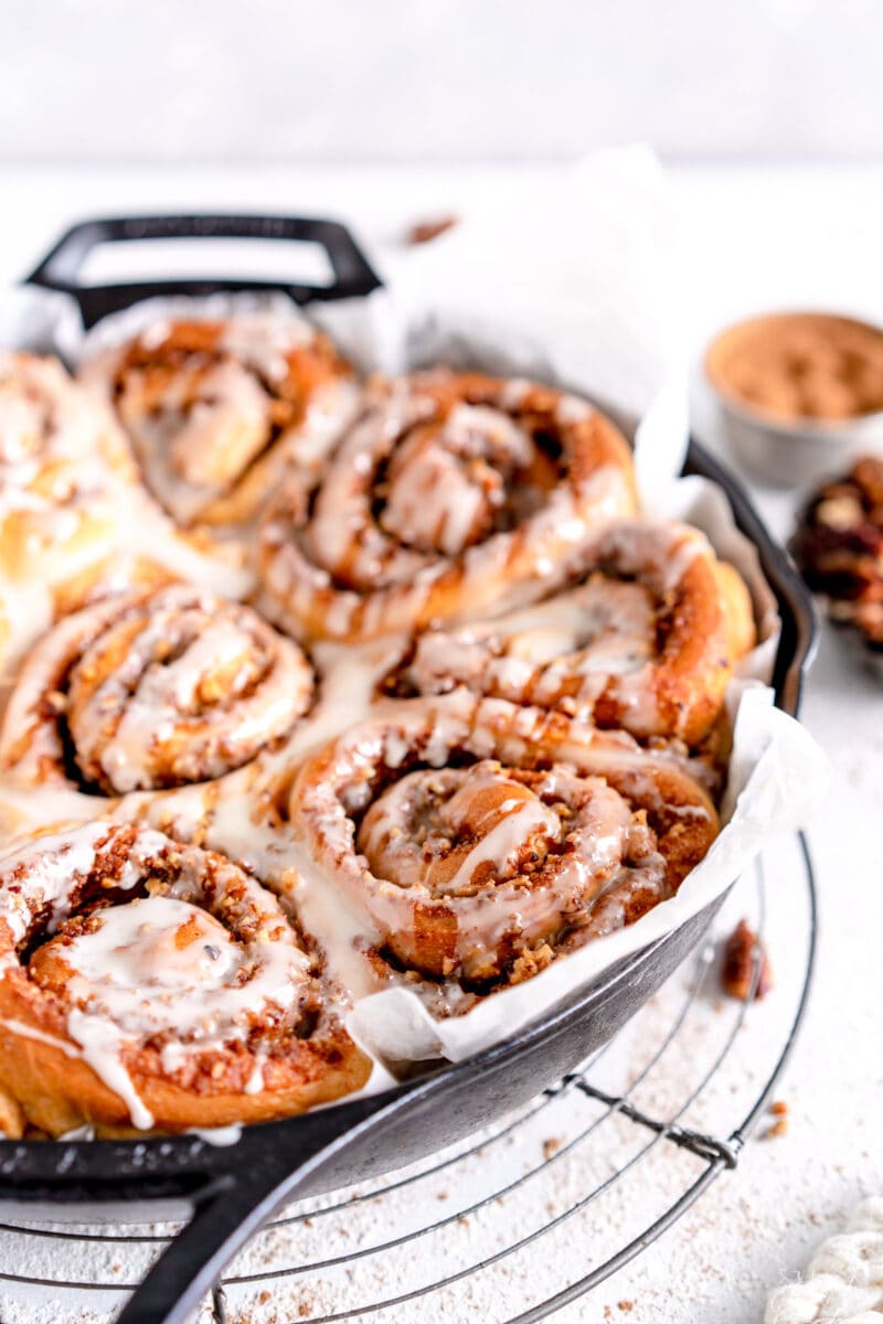 close up vegan cinnamon rolls with frosting
