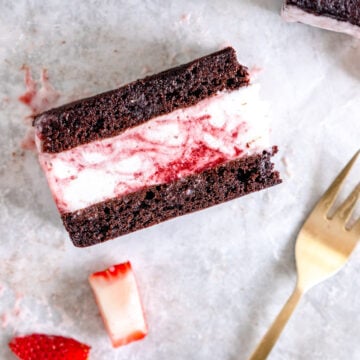 brownie ice cream sandwich with strawberry sauce