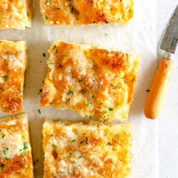 garlic bread on paper with knife