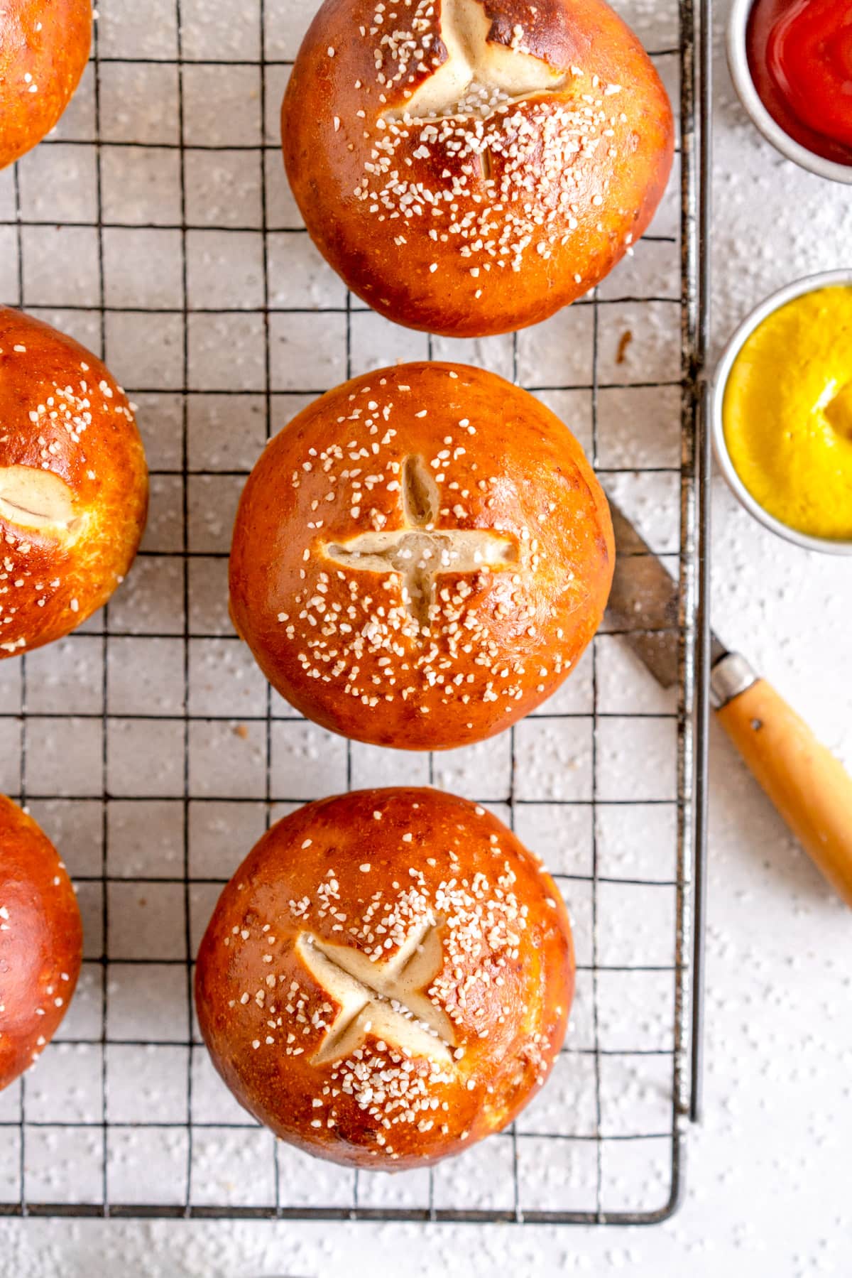 pretzel bun with salt on a wire rack