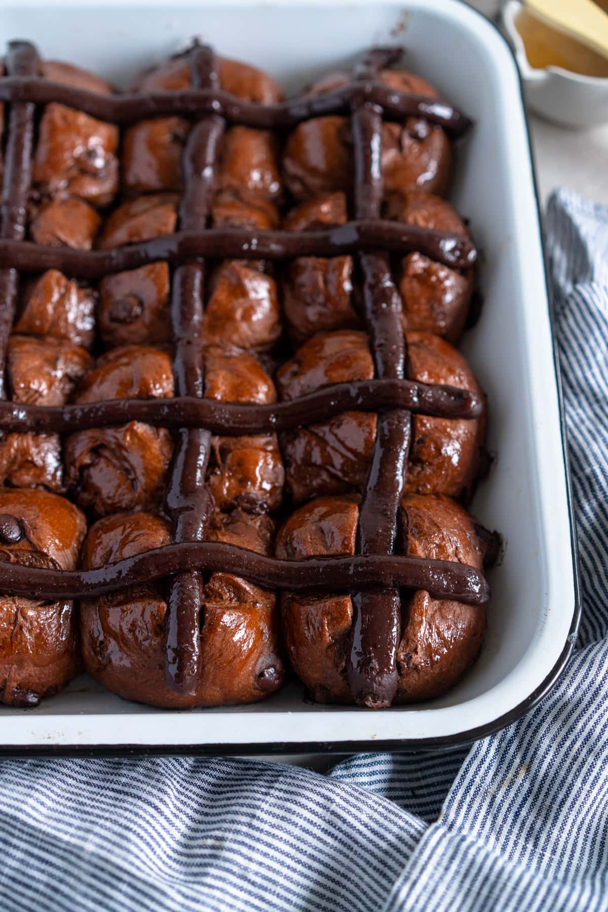 hot cross buns with pastry cream cross on tea towel