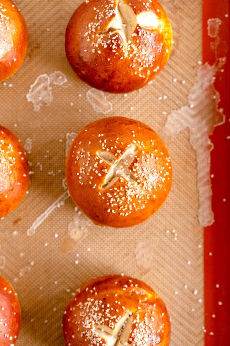 baked pretzel bun with salt on silicone mat