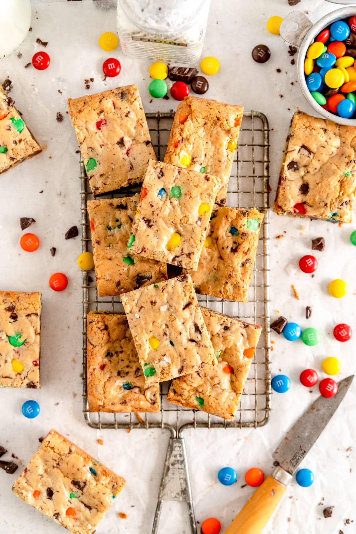 cookie bars on wire rack with m&ms and knife