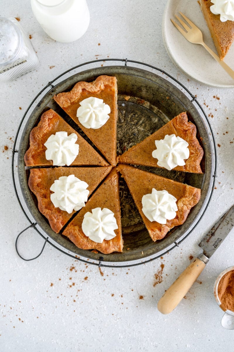 whole pumpkin pie with cream piped on top