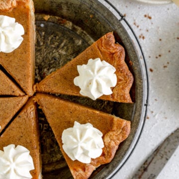 slices of pumpkin pie with whipped cream topping
