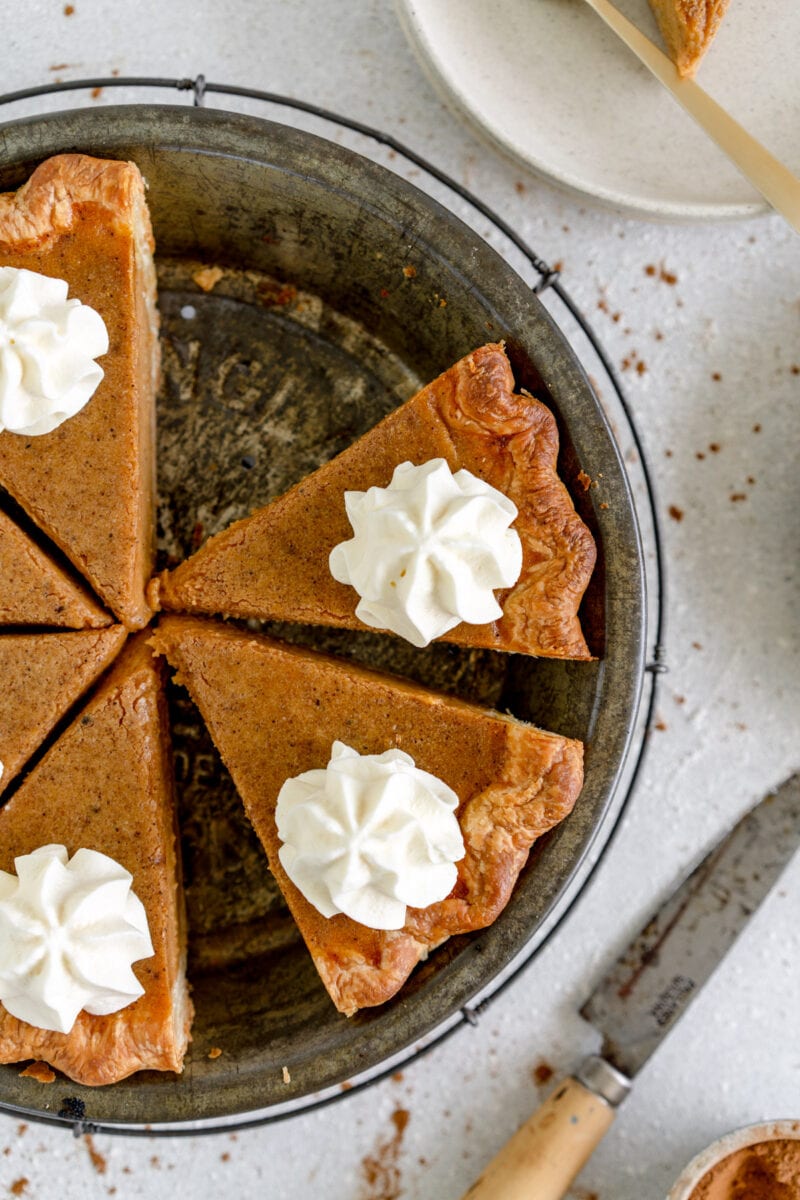 slices of pumpkin pie with whipped cream topping