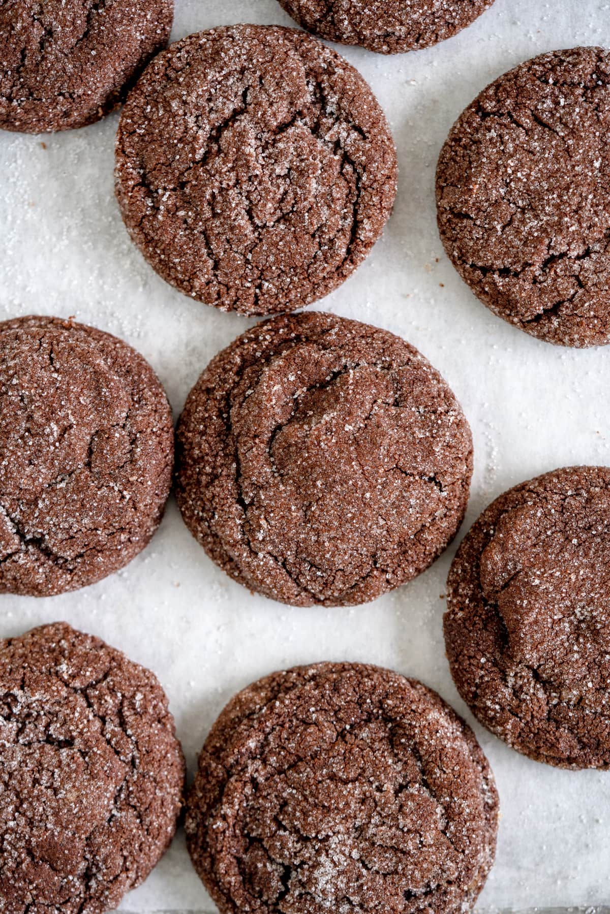 close up image of chocolate cookies on parchment paper